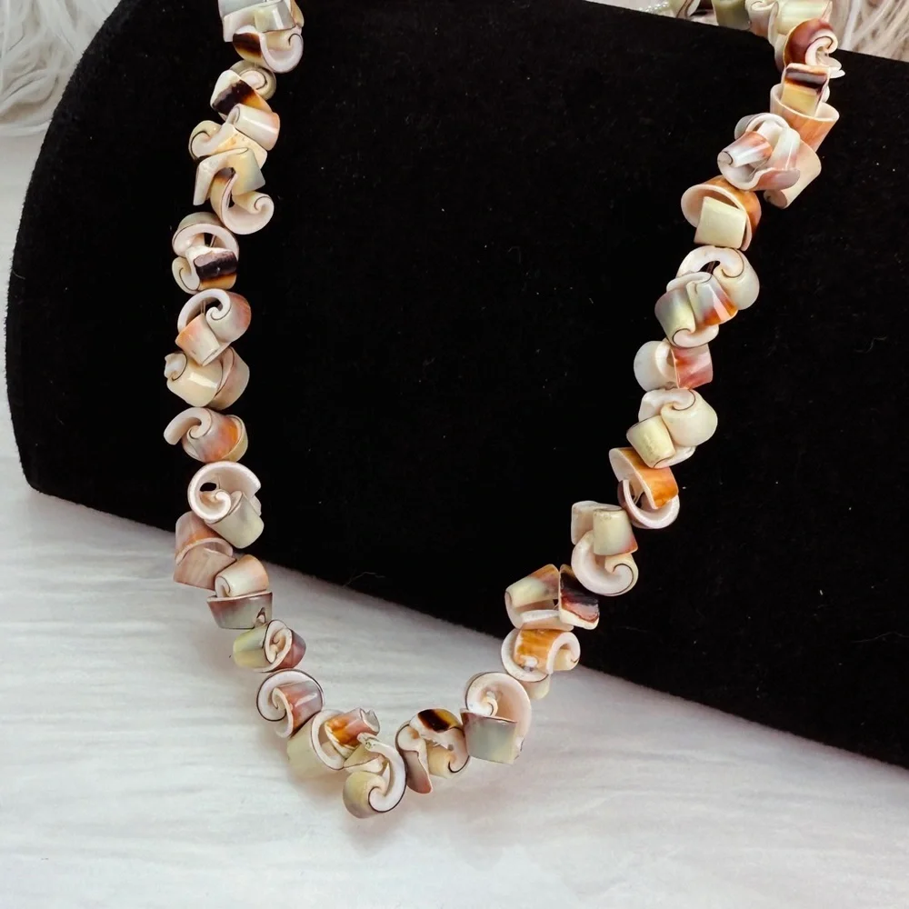 Beautiful vintage necklace composed of curly-cut conch shell beads individually